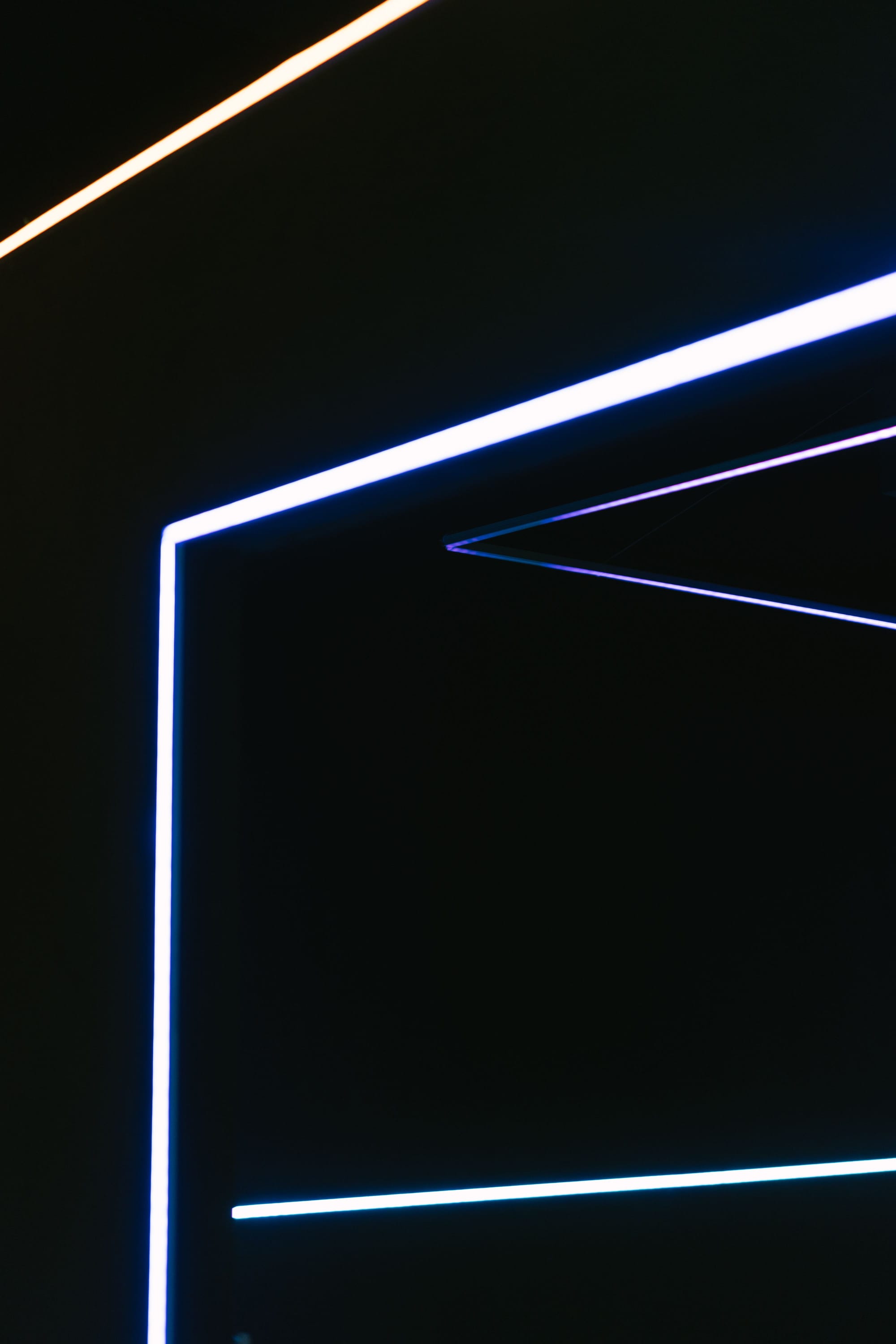 a group of thin thin poles against a black background